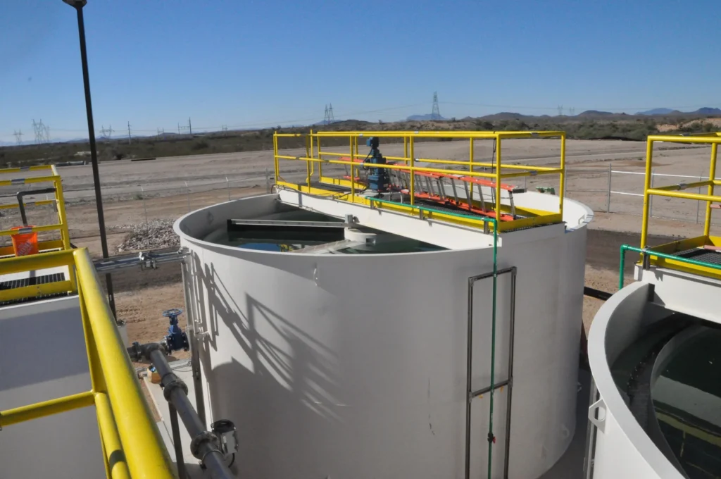 Water treatment clarifier tanks with walkway platforms and yellow safety railings