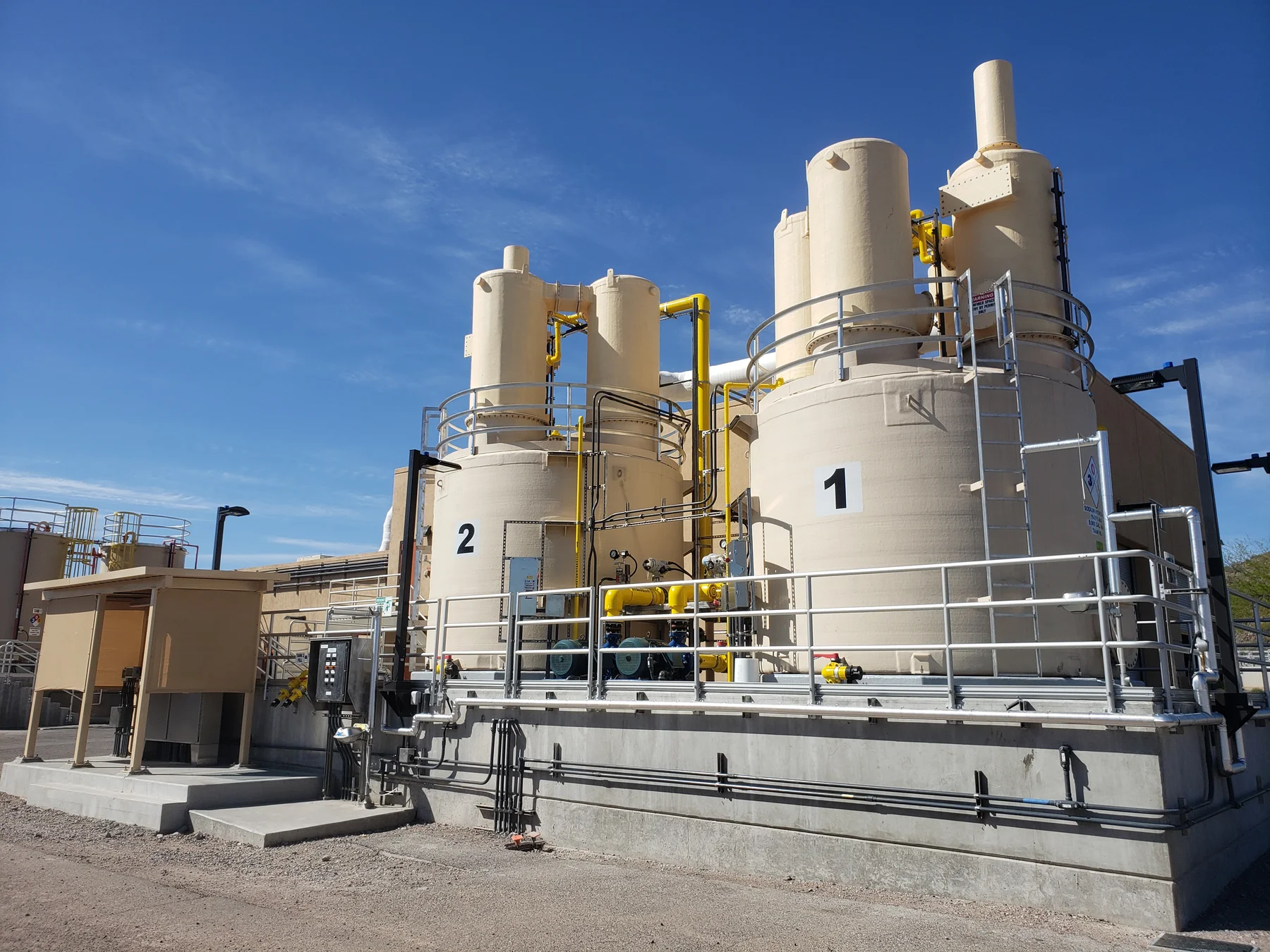 Numbered water treatment process vessels with exhaust stacks at a treatment plant