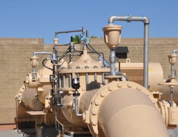Close-up of large water main pump assemblies and instrumentation piping