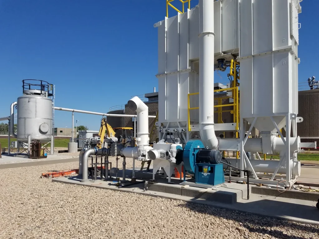 Pipeline injection equipment with storage vessels, blower, and piping under clear skies