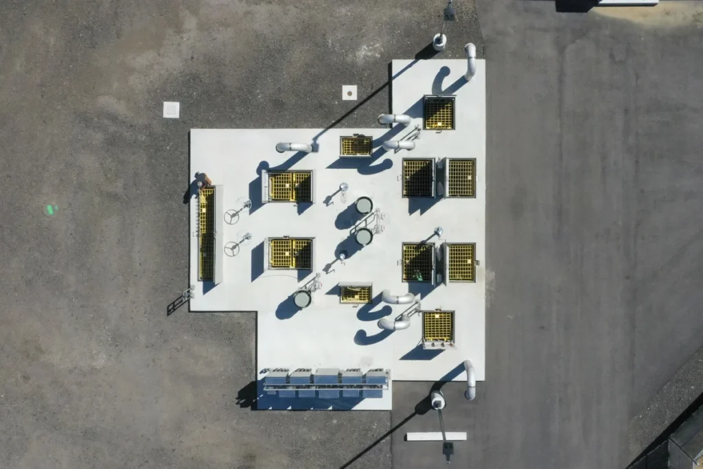 Aerial view of lift station rooftop showing ventilation grates, access hatches, and piping